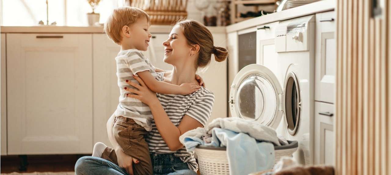 A woman with a child while gathering the laundry