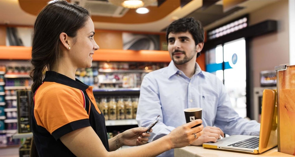 Repsol service station worker with a customer