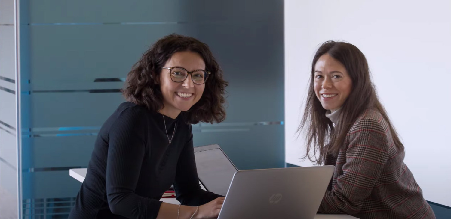 Two women with a laptop in meeting room
